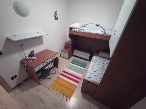 a small room with a desk and a bunk bed at Caorer in Predazzo