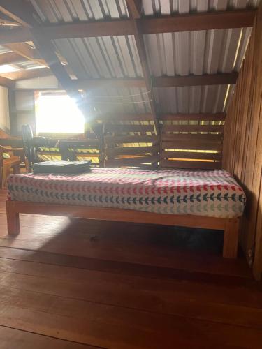 a bench in a room with a roof at Silversands retreat hostel in Corn Island