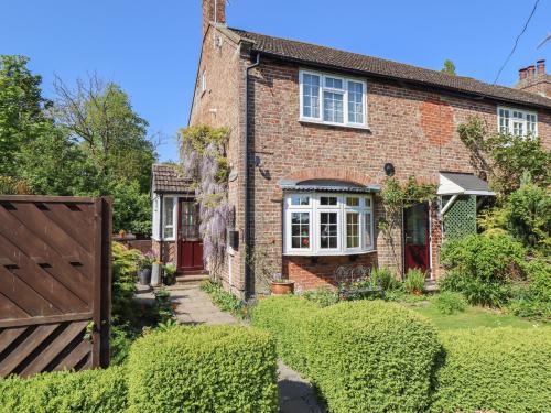 a brick house with a red door and a gate at 1 Eastview in Louth