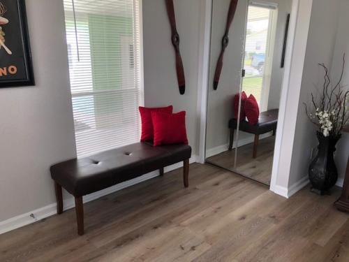 a living room with a bench and a mirror at 748P Z2b VILLAGE OF DEL MAR by REMAX Premier in The Villages