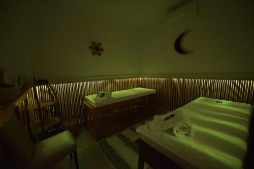 a room with two beds and a cot and a moon at RIAD KALE POLIS in Marrakech