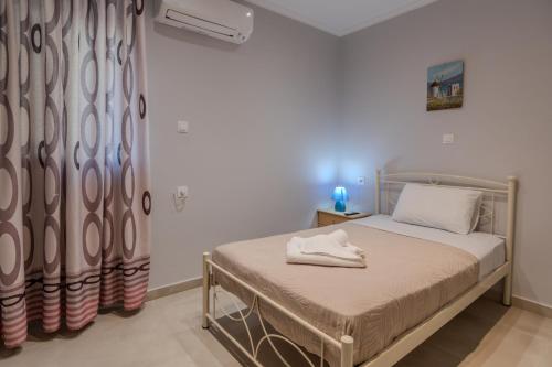 a bedroom with a bed and a curtain at Dionysis Elegant Cozy Apartment in Filiatra