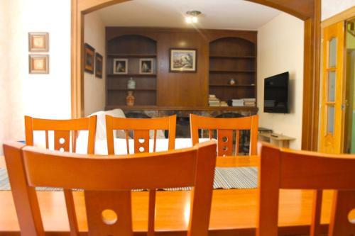 a dining room and kitchen with a table and chairs at House with Pool and Sea Views in Alella
