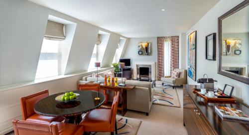 a living room with a table and some chairs at The Stafford London in London