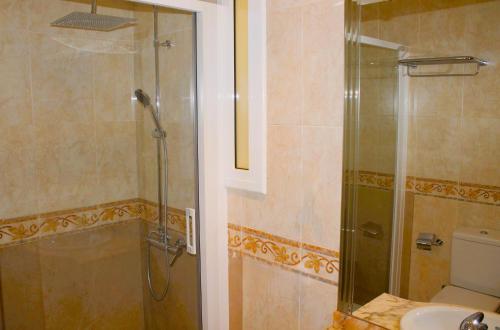 a bathroom with a shower and a toilet and a sink at House with Pool and Sea Views in Alella