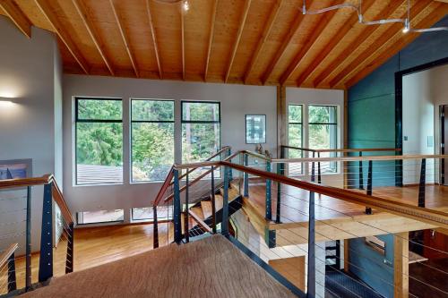 a room with wooden ceilings and stairs in a house at Puget Sound Orca Retreat in Poulsbo