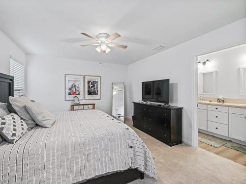 a bedroom with a bed and a ceiling fan at 928 Z5 VILLAGE OF LAKE DENHAM by REMAX Premier in Leesburg