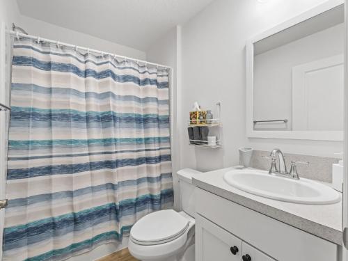 a white bathroom with a sink and a toilet at 928 Z5 VILLAGE OF LAKE DENHAM by REMAX Premier in Leesburg