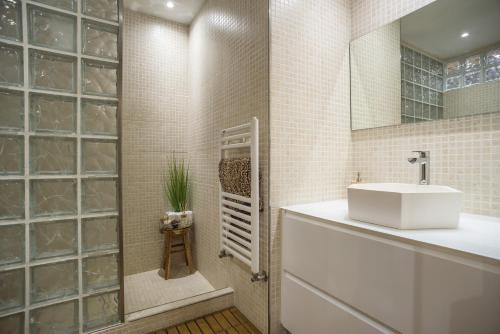 a bathroom with a white sink and a shower at Holiday Villa Benmar in Castellón de la Plana
