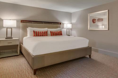 a bedroom with a large white bed with two lamps at Charming Retreat for 2 Near Downtown & Broadway in Nashville