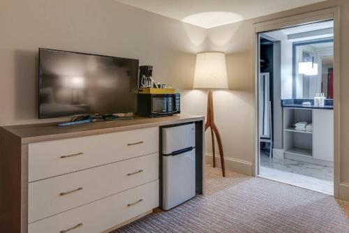 a room with a dresser with a flat screen tv at Charming Retreat for 2 Near Downtown & Broadway in Nashville