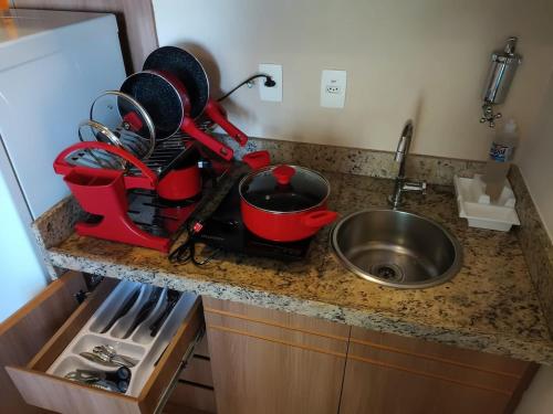 a kitchen counter with a mixer and a sink at Apart no Hotel Saint Moritz n° 810 in Brasilia