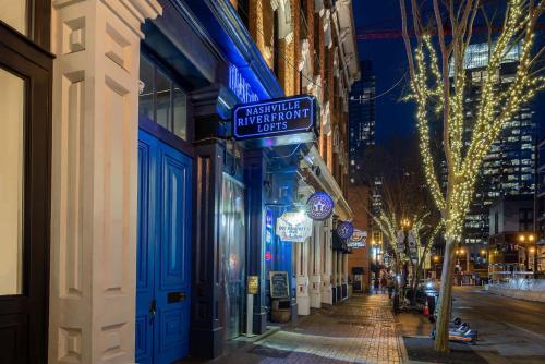 a street at night with a sign on a building at Cozy Retreat for 2 Heart of DT Near Broadway in Nashville