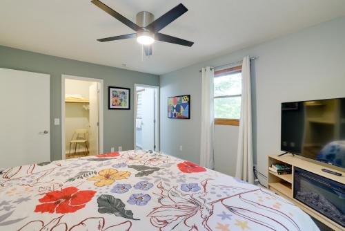 a bedroom with a bed and a ceiling fan at Hot Tub and Fire Pit Holiday Island Getaway! in Golden
