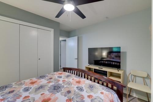 a bedroom with a bed and a flat screen tv at Hot Tub and Fire Pit Holiday Island Getaway! in Golden