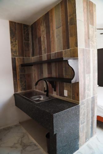 a kitchen counter with a sink in a room at San Carlos Valladolid in Valladolid