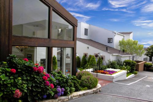 a building with a lot of flowers in front of it at Lobos Lodge in Carmel