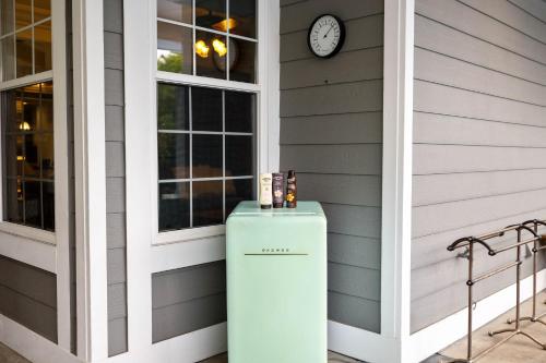 a refrigerator on the side of a house with a clock at Sprawling Escondido Estate Garden Pool Games ADU's in Escondido