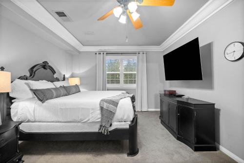 a bedroom with a bed and a flat screen tv at Sprawling Escondido Estate Garden Pool Games ADU's in Escondido