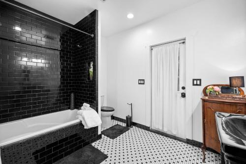 a bathroom with a tub and a toilet and a sink at Sprawling Escondido Estate Garden Pool Games ADU's in Escondido