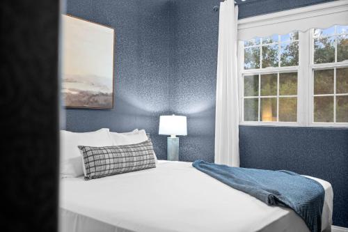 a bedroom with a white bed and a window at Sprawling Escondido Estate Garden Pool Games ADU's in Escondido