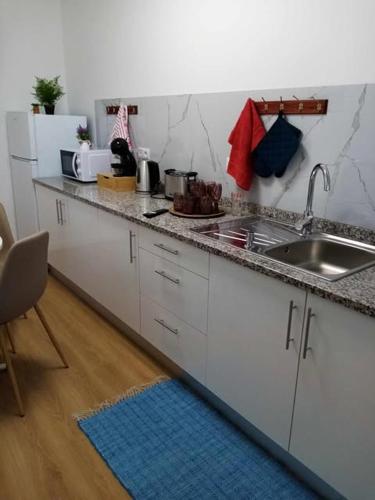 a kitchen with a sink and a counter top at Vivenda Silva in Seixal