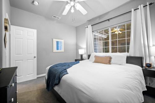 a bedroom with a large white bed and a window at Sprawling Escondido Estate Garden Pool Games ADU's in Escondido
