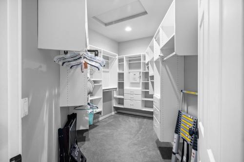 a walk in closet with white cabinets at Sprawling Escondido Estate Garden Pool Games ADU's in Escondido