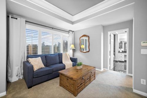 a living room with a blue couch and a table at Sprawling Escondido Estate Garden Pool Games ADU's in Escondido