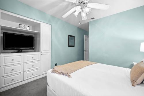 a blue bedroom with a bed and a tv at Sprawling Escondido Estate Garden Pool Games ADU's in Escondido
