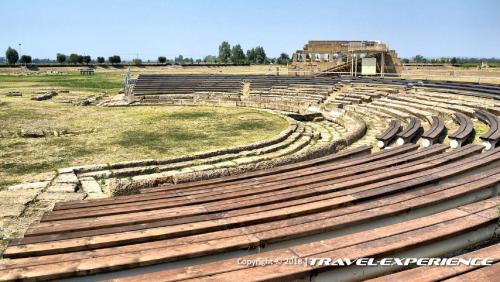 an amphitheater with wooden seats in a field at Basilicata Host to Host - La Conchiglia in Metaponto
