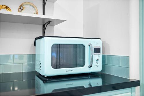a microwave sitting on top of a counter in a kitchen at Sprawling Escondido Estate Garden Pool Games ADU's in Escondido