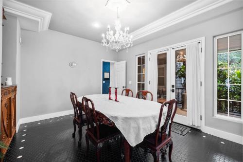 a dining room with a table with chairs and a chandelier at Sprawling Escondido Estate Garden Pool Games ADU's in Escondido