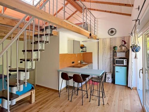 a kitchen with a table and chairs in a room at I suoni del bosco in Casalborgone