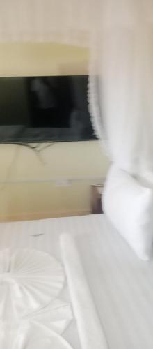 Ένα ή περισσότερα κρεβάτια σε δωμάτιο στο Marcello LODGE