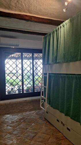 a room with a bunk bed and a window at Kite Hostel Stagnone in Marsala