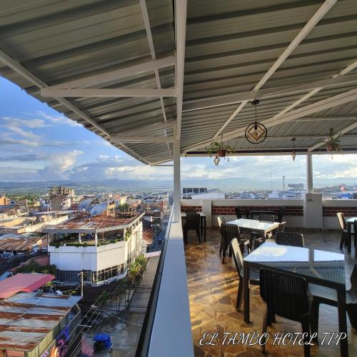 a view from the balcony of a restaurant with tables and chairs at Hotel El Tambo de Tarapoto-Perú in Tarapoto