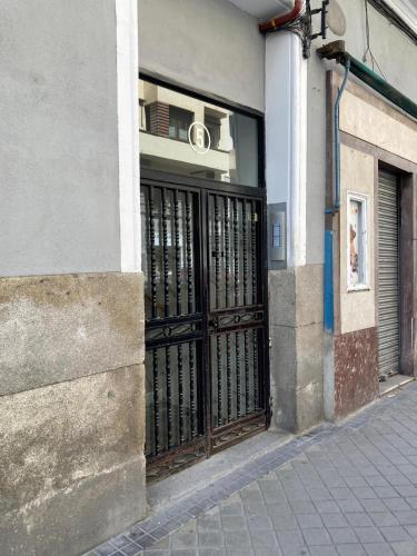 a building with a gate on the side of a street at OLBLANC Plaza de España by Batuecas in Madrid