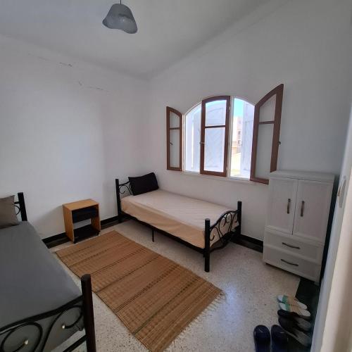 Ένα ή περισσότερα κρεβάτια σε δωμάτιο στο Maison de plage pied dans l'eau pour familles