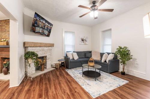 a living room with a couch and a fireplace at Steps 2 High ST - BIG Patio - Private parking- OSU in Milo