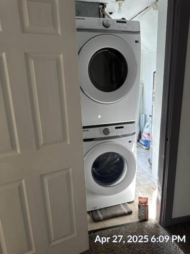 a washing machine is sitting next to a door at Steps 2 High ST - BIG Patio - Private parking- OSU in Milo