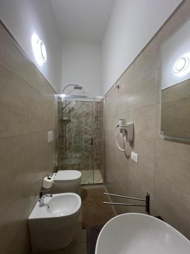 a bathroom with two toilets and a sink and a shower at Perla D'Oriente - Affittacamere in Otranto