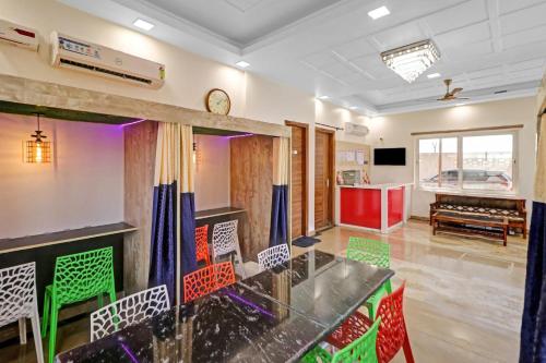 a room with a table and chairs in a room at Hotel O Safari Inn in Hāpur