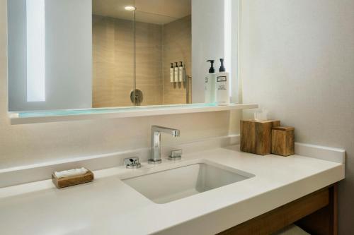 a bathroom with a white sink and a mirror at Newport Marriott Hotel & Spa in Newport