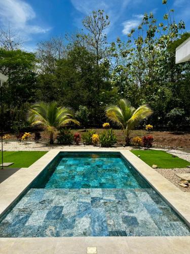 a swimming pool in the middle of a yard at Stylish Private Tropical Escape-10 mins from Tamarindo in Villarreal