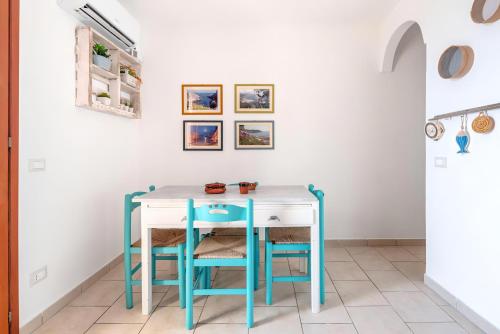 a blue and white table and chairs in a room at Terrazza fronte Mare in Castro di Lecce