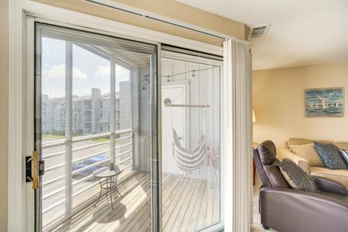 a sliding glass door leading to a balcony with a couch at 1 Mi to Ferry Port Clinton Condo with Beach View! in Port Clinton