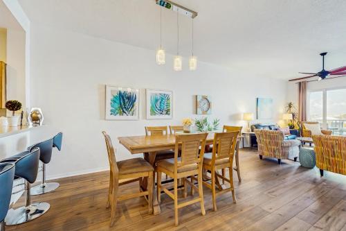 a dining room with a table and chairs at Harborview Grande 402 in Clearwater Beach