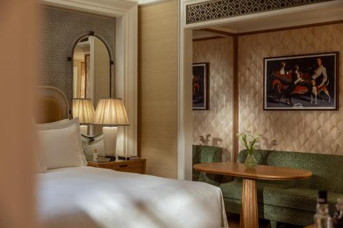 a hotel room with a bed and a table at The Surrey, A Corinthia Hotel in New York