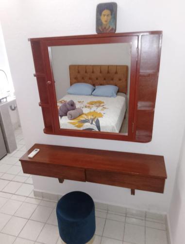 a mirror above a bed with a teddy bear on it at Casa Soliman - Cancun Centro Market28 Cable TV HBO FOX Netlix in Cancún